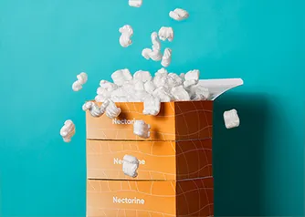 Stacked custom folding boxes with branded design and packing peanuts spilling out