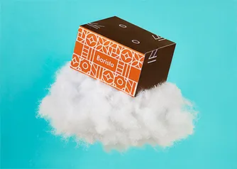 Packwire custom SBS folding box with ornate coffee brand design floating on a cloud