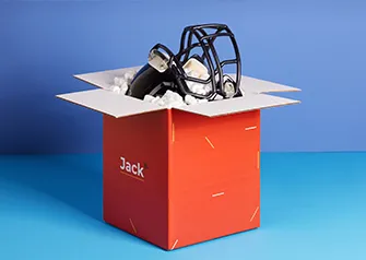 Custom printed red shipping box open with packing peanuts and football helmet by Packwire