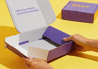 Hands assembling a Packwire custom printed mailer box showing easy fold construction